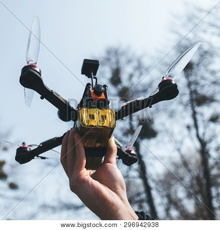 Pilot Racing Drone Holds In His Hand Fpv Copter Before Launching It. A Small High-speed Aircraft Wit