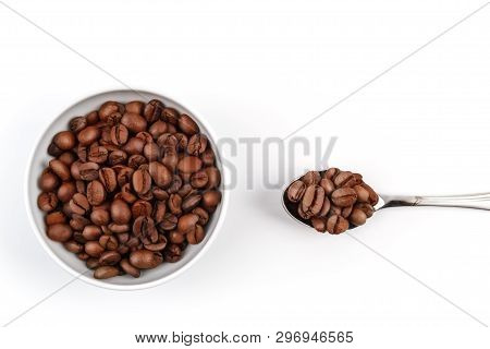 Cup And Spoon Filled With Roasted Coffee Grains. Coffee. Layout. Flat Lay.