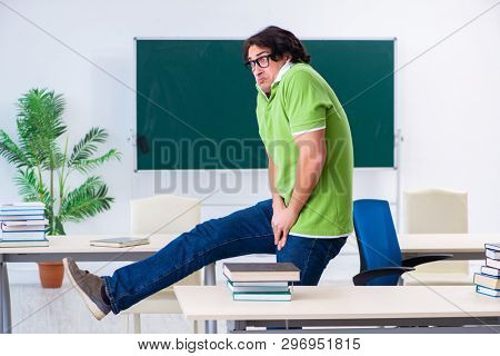 Male student suffering from urge in the classroom  