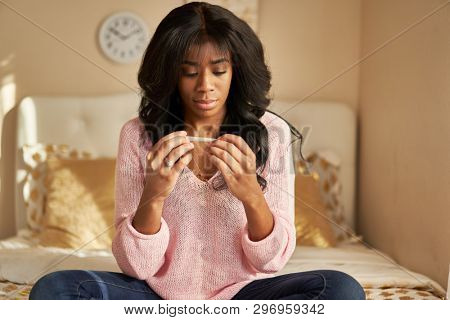 african american woman holding cannabis pre-roll