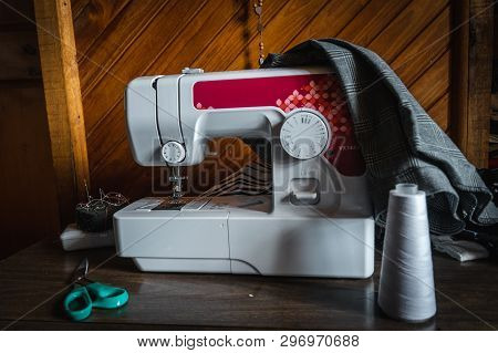 Front View Of A Modern Electric Sewing Machine Isolated On White With Scissors