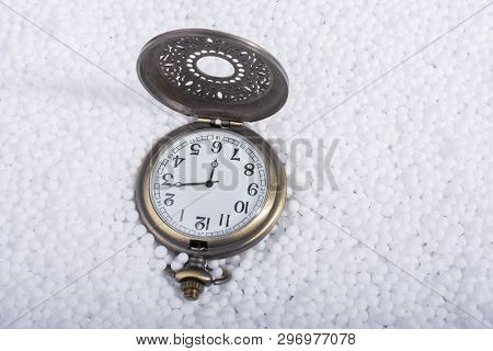 Retro Pocket Watch On White Polystyrene Balls