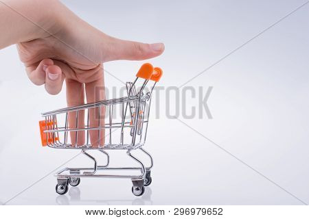 Hand Holding A Cart On A White Background