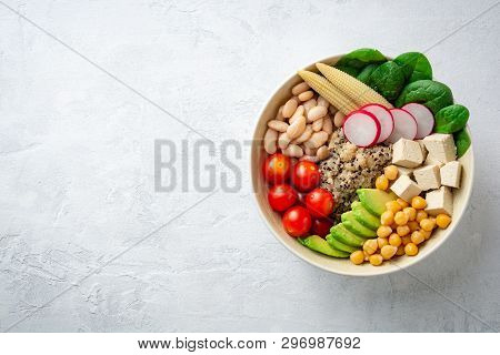 Healthy Vegan Buddha Bowl With Spinach, Tomato, Chickpea, Quinoa, Radish, Beans, Avocado, Mini Corn