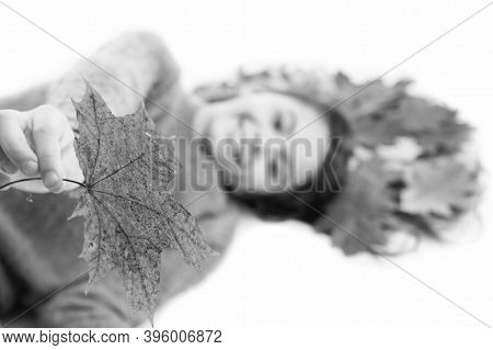 Take It. Child Giving Leaf Close Up. Girl Cute Kid Long Hair Lay On White Background With Fallen Lea