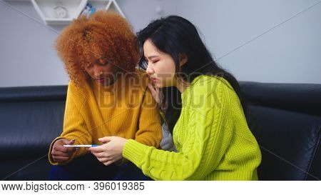 Unwanted Pregnacy Concept. Best Friends Dissapointed With Positive Pregnancy Test. High Quality Phot