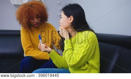 Unwanted Pregnacy Concept. Best Friends Dissapointed With Positive Pregnancy Test. High Quality Phot