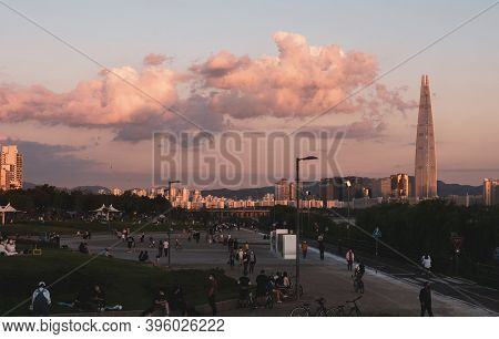 Seoul,south Korea-september 2020: People Enjoying The Sunset At Ttukseom Han River Park With Seoul L