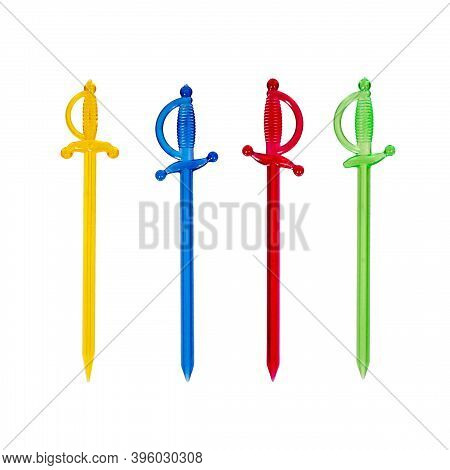Decorated With Multi-colored Transparent Cocktail Sticks In The Form Of A Sword Or Rapier. Isolated 