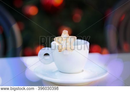 Violet Bokeh On White Porcelain Coffee Cup With Saucer And Wooden Decorative Star With Snowflakes. B