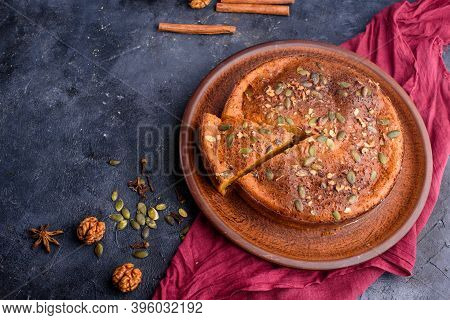 Pumpkin Pie With Lemon Zest, Pumpkin Seeds, Cinnamon, Fragrant And On A Dark Background. Healthyfood