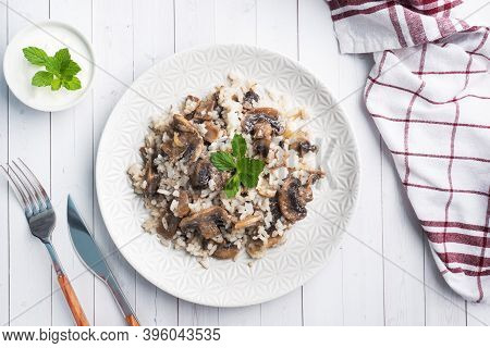 Risotto With Mushrooms On A White Plate. Boiled White Rice With Champignons In Cream Sauce. Light Wo