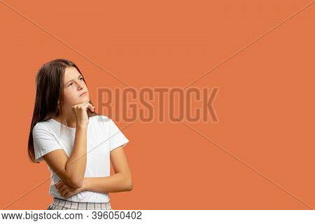 Pensive Child. Commercial Background. Hard Choice. Inspiration Idea. Portrait Of Doubtful Puzzled Co