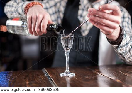 Charismatic Barman Places The Finishing Touches On A Drink In The Bar