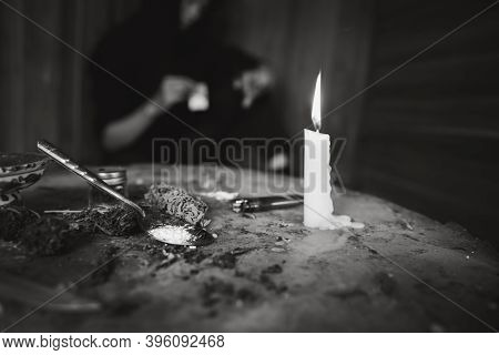 Drug Addicts In The Dark Room. Addict/junkie Preparing Drugs With A Spoon And Lighter. White Powder 
