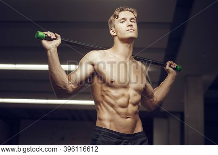 Fitness Man At Workout In Gym With Bodybar Stretching Muscles. Workout Fitness And Bodybuilding Heal