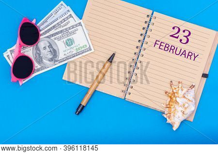 February 23rd. 23rd Day Of February. Travel Plan Flat Design With Notepad Written Date, Pen, Glasses