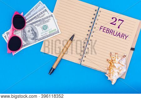 February 27th. 27th Day Of February. Travel Plan Flat Design With Notepad Written Date, Pen, Glasses