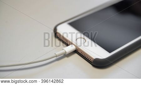 Close-up Of Connecting Charging To Your Phone. Media. Special Charging Connector For Branded Phone. 