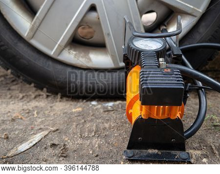 Pump Up The Autowheel Compressor On The Road. Car Electro Pump.