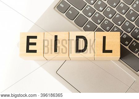 Word Eidl. Wooden Cubes With Letters Isolated On A Laptop Keyboard. Business Concept Image.