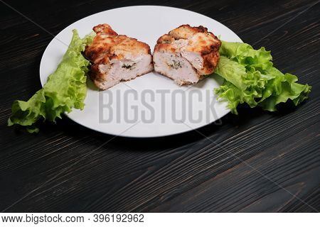 Home Chop Cut In Half Made In France. Cutlet De Volaille With Stuffing, Breaded With Lettuce. French