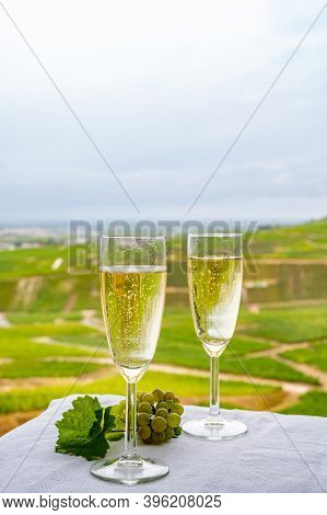 Tasting Of French Sparkling White Wine With Bubbles Champagne On Outdoor Terrace With View On Grand
