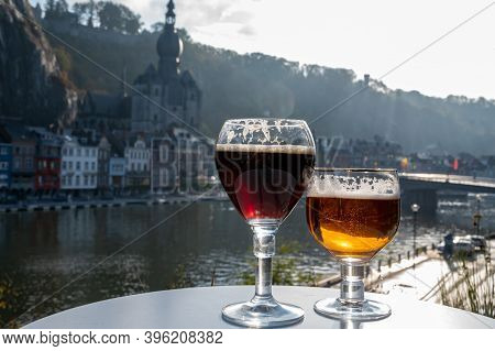 Drinking Of Dark And Strong Belgian Abbey Beer With Cheeses With Nice View On Maas River And Town Di