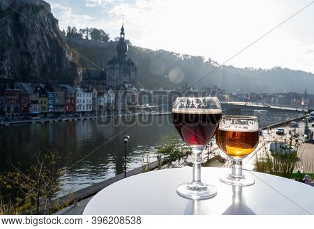 Drinking Of Dark And Strong Belgian Abbey Beer With Cheeses With Nice View On Maas River And Town Di