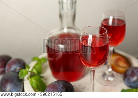 Delicious Plum Liquor Served On Tray, Closeup. Homemade Strong Alcoholic Beverage