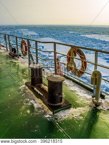  Lapland. The excursion to the arctic tourist cruise on the sea icebound. The concept of active and extreme tourism. The strip of ice crumb spreads behind the icebreaker
