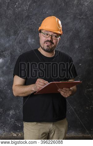 Middle-aged Man In A Helmet Construction Superintendent