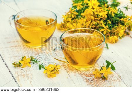 Two Cups Of Hypericum Herbal (tutsan) Tea On Wooden Grunge Table