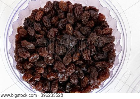 Bowl Of Raisins In Macro View With White Background