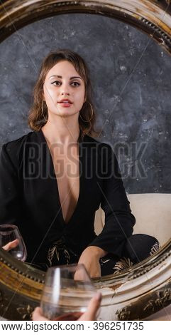 Beautiful Young Lady In Black Jacket Sitting Afront Of The Vintage Mirror With Glass Of Wine Studio 