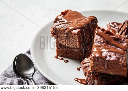 Vegan Brownie Squares With Dark Chocolate On A Gray Plate, Gray Background. Vegan Dessert Concept.