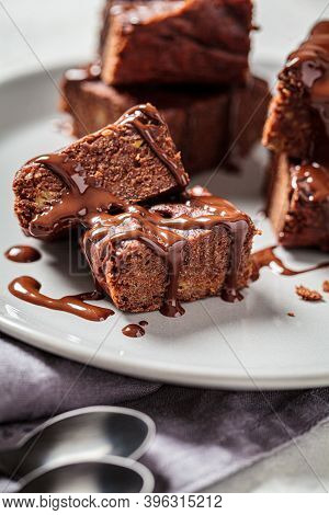 Vegan Brownie Squares With Dark Chocolate On A Gray Plate, Gray Background. Vegan Dessert Concept.