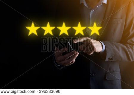 Man Hand Smartphone Showing On Five Star Excellent Rating.pointing Five Star Symbol To Increase Rati