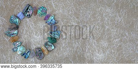 Crystal And Abalone Shell Circle Website Header - Tumbled Stones And Slices Of Abalone Shell Neatly 