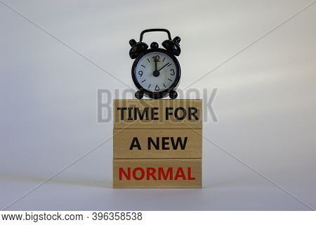 Time For A New Normal. Wooden Blocks With Words 'time For A New Normal'. White Table. Black Alarm Cl