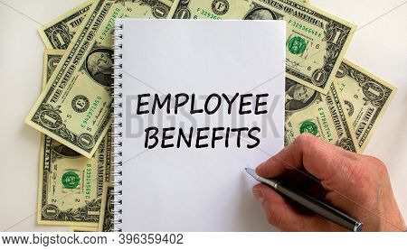 Employee Benefits. Male Hand Writing 'employee Benefits' On White Note, On White Background. Dollar 