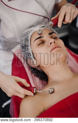 Woman Does Anti-aging Procedures With Cosmetologist. High Quality Photo