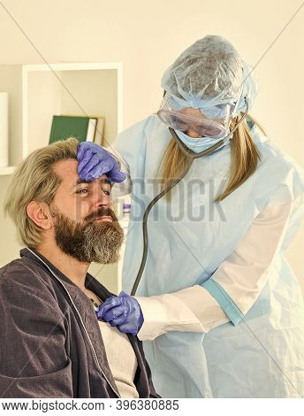 Covid 19. Diagnosis Of Pneumonia. Sars Concept. Doctor Protective Equipment Examines Patient Suspect