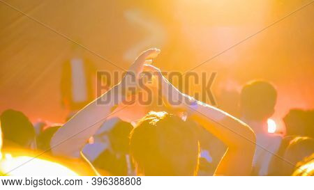 Teenage Boy Partying, Cheering, Raising Hands Up And Clapping At Rock Concert In Front Of Stage Of N
