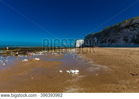 MARGATE, Kent, UK: 21 May 2020: Visitors to Margate's Main Sands beach surrounded by white cliffs during the heatwave in Britain.