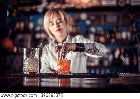 Portrait Of Girl Bartender Demonstrates The Process Of Making A Cocktail