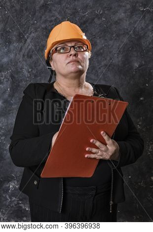 Middle-aged Woman Construction Superintendent In Helmet Studio Portrait.