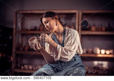 Stylish Artisan Making Ceramic Pot On The Pottery Wheel . Folk Craft.