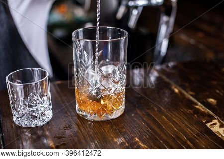 Charming Woman Mixologist Demonstrates His Skills Over The Counter Behind The Bar