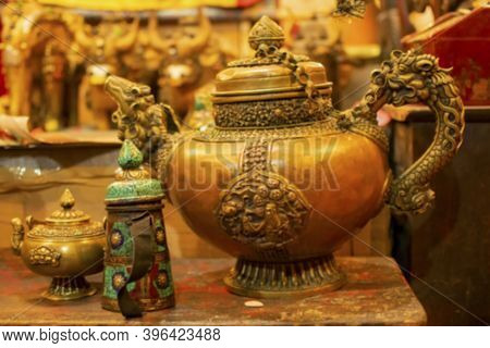 Blurred Image Of A Tibetan Tea Pot With Chinese Dargons Emblemed On It, For Sale At Leh Market, Unio